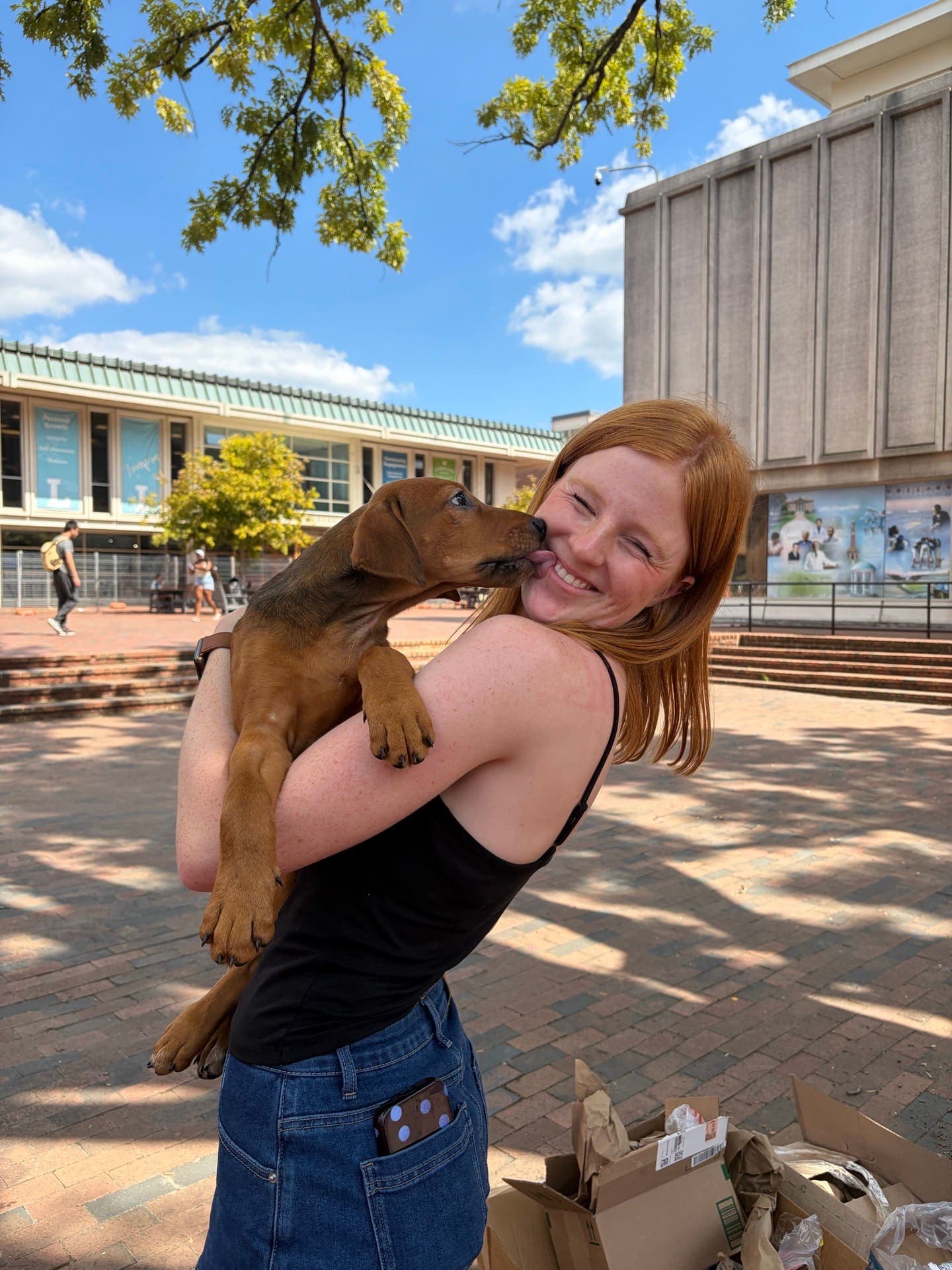 A member holding a puppy at Puppies & PCT